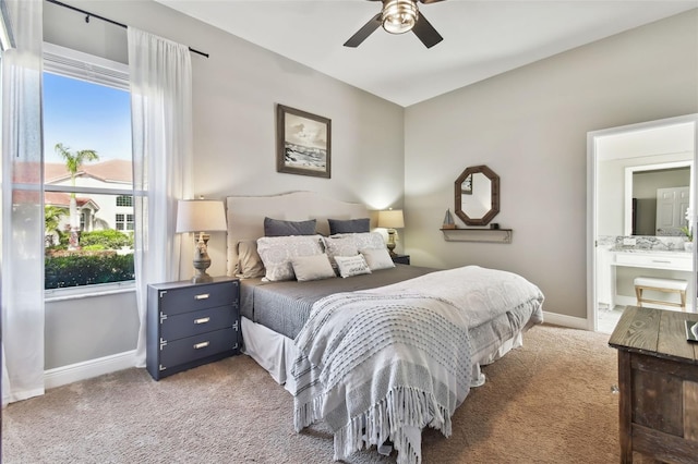 bedroom with light carpet, ceiling fan, and ensuite bathroom