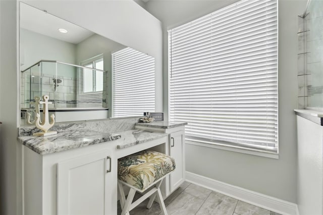 bathroom with walk in shower and vanity