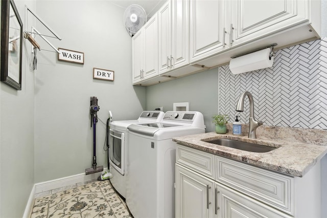 laundry room with cabinets, sink, and washer and clothes dryer