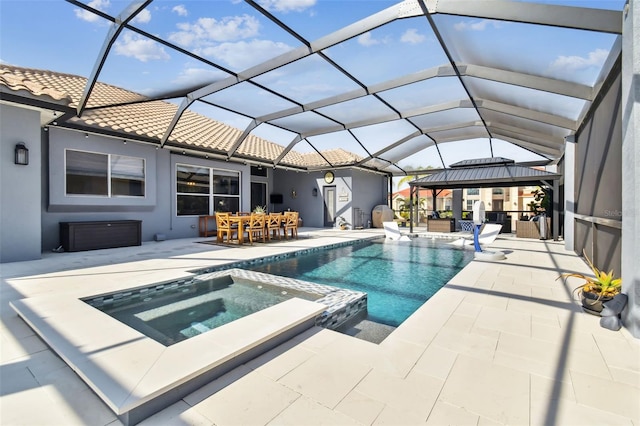 view of swimming pool with a gazebo, a patio area, glass enclosure, and an in ground hot tub