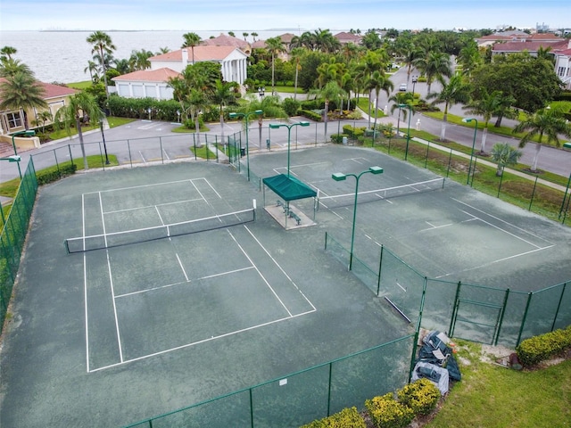 view of tennis court with a water view