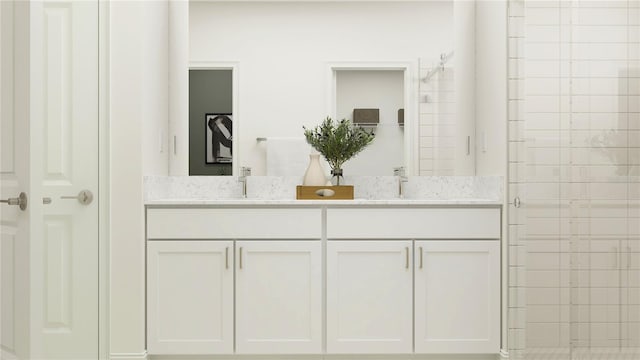 bathroom with vanity and tiled shower