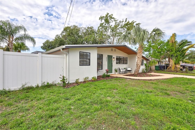 ranch-style house with a front lawn