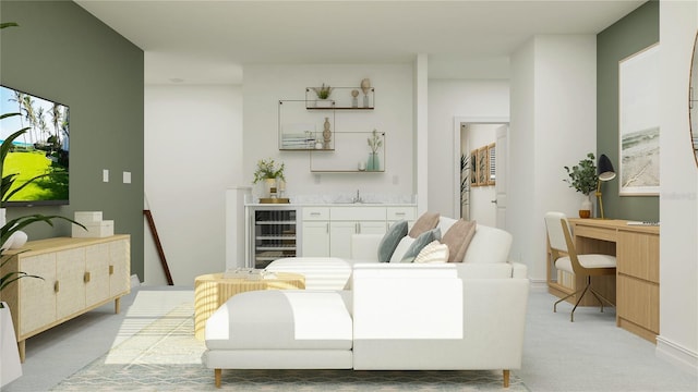 living room with light colored carpet, beverage cooler, and wet bar