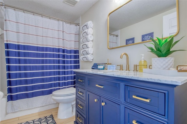 bathroom with wood-type flooring, toilet, a textured ceiling, and vanity