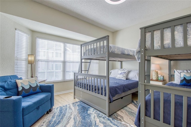 bedroom featuring hardwood / wood-style flooring and a textured ceiling