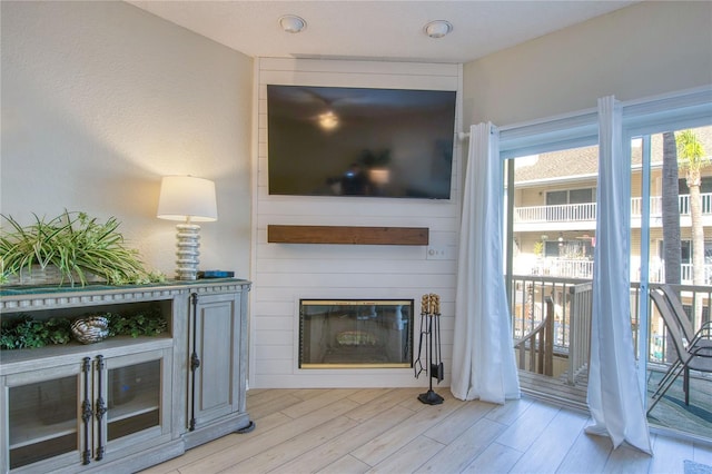 unfurnished living room featuring a fireplace and light hardwood / wood-style flooring