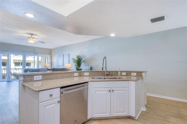 kitchen featuring light wood-type flooring, stainless steel dishwasher, sink, and white cabinets