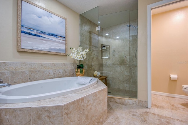 bathroom featuring separate shower and tub and toilet