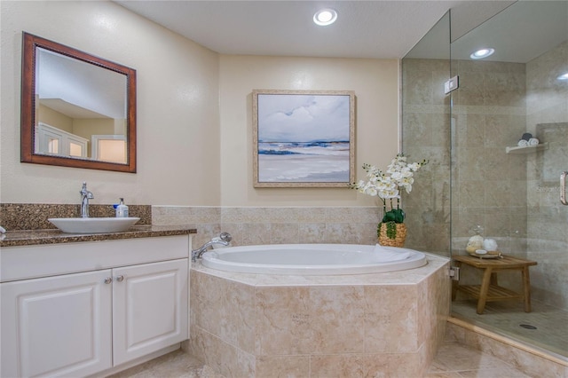 bathroom featuring independent shower and bath, vanity, and tile patterned flooring