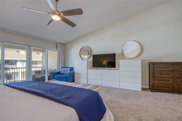 carpeted bedroom featuring lofted ceiling, access to exterior, a textured ceiling, and ceiling fan