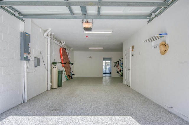 garage with a garage door opener and electric panel