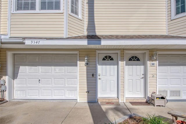 garage with concrete driveway