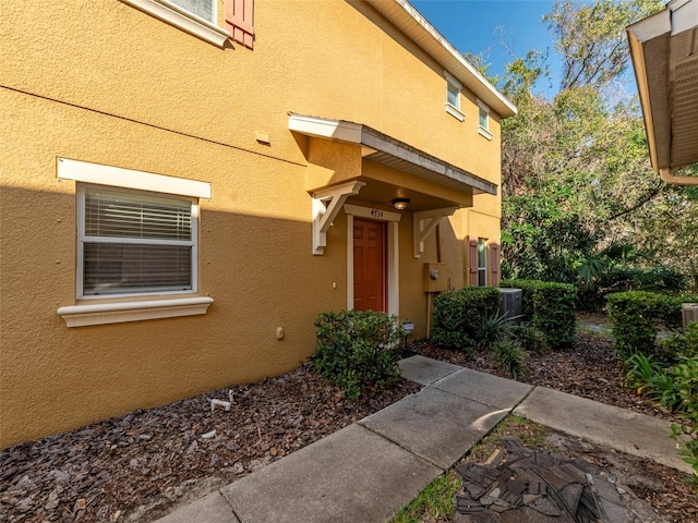 doorway to property featuring central air condition unit