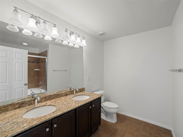 full bathroom with tiled shower / bath combo, vanity, tile patterned flooring, and toilet