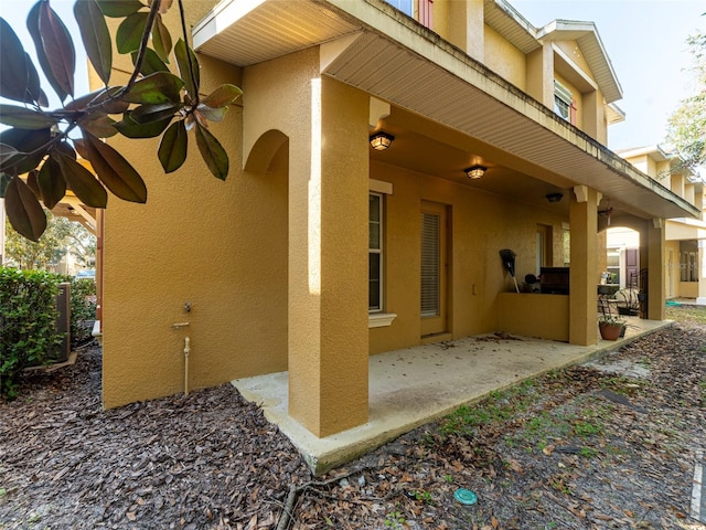 view of home's exterior featuring a patio and ceiling fan