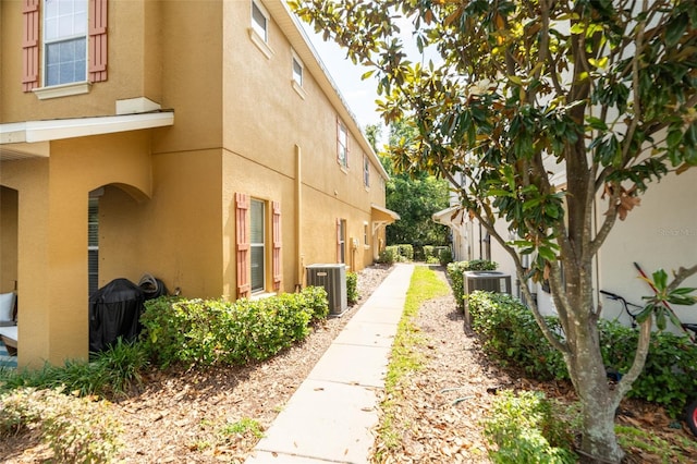 4734 Chatterton Way, Riverview, FL 33578 - view of side of property featuring stucco siding and central AC