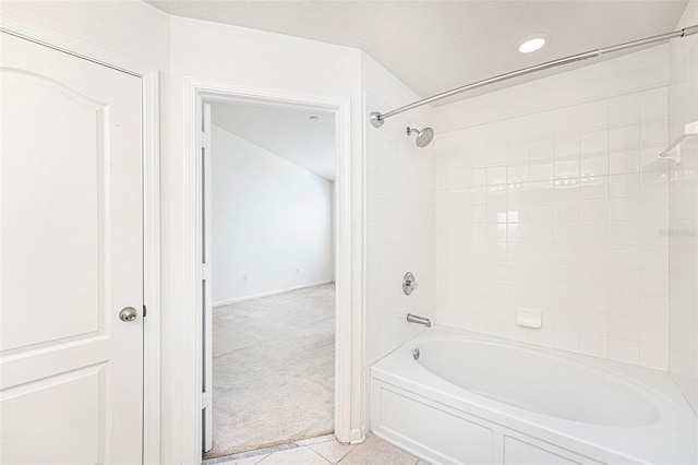 bathroom with tiled shower / bath combo and tile patterned floors