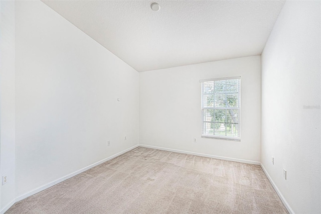 carpeted empty room with a textured ceiling