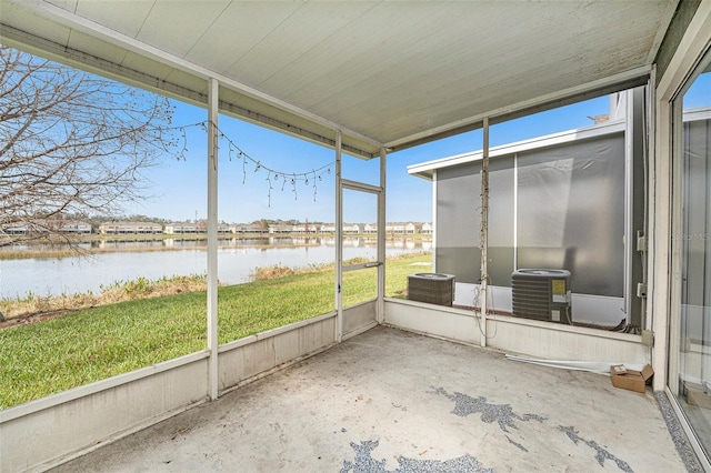 unfurnished sunroom with a water view