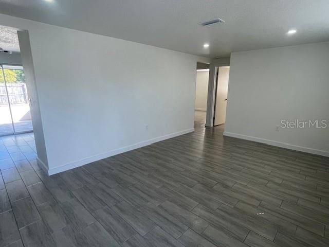 empty room with dark hardwood / wood-style floors