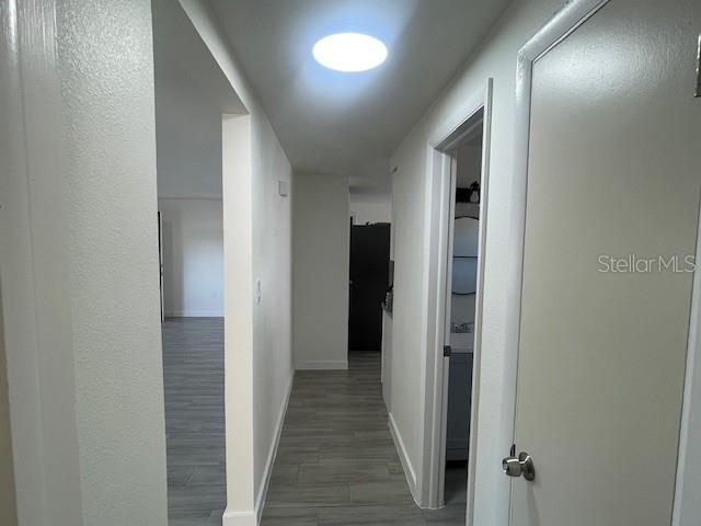 hallway with dark hardwood / wood-style floors