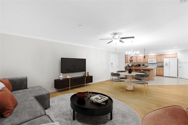 living room with crown molding, ceiling fan with notable chandelier, and light hardwood / wood-style flooring