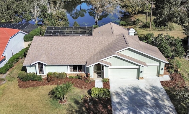 view of front of house with a garage, a lanai, and a water view