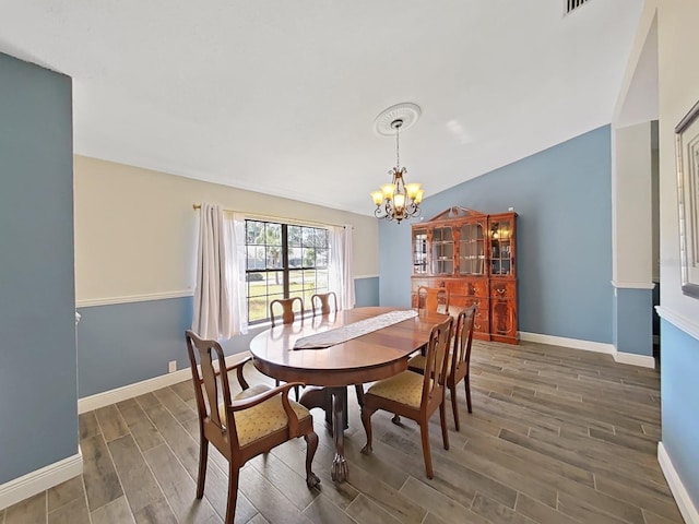 dining room featuring lofted ceiling and a notable chandelier