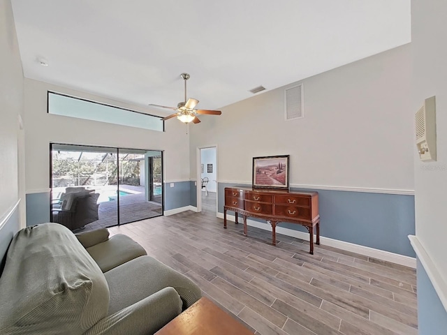 living room with ceiling fan and light wood-type flooring