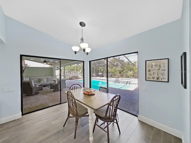 dining area with a notable chandelier and light hardwood / wood-style flooring