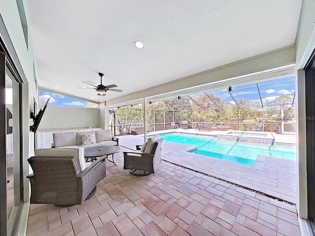 view of swimming pool with ceiling fan, outdoor lounge area, a patio area, and a lanai