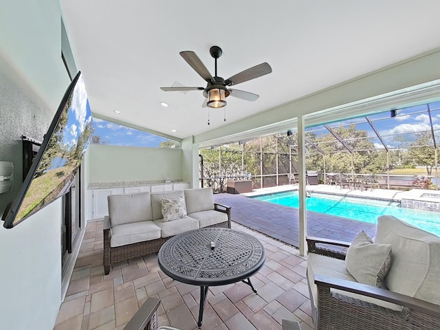 view of swimming pool featuring an outdoor living space, a patio, a lanai, and ceiling fan