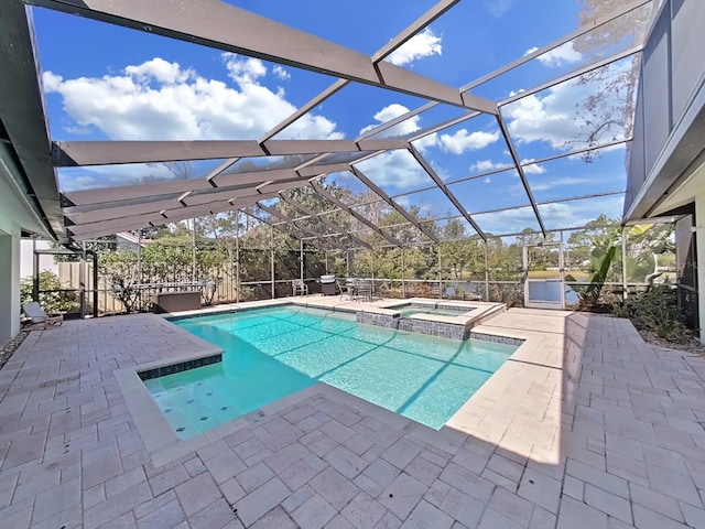 view of pool featuring a lanai, a patio, and an in ground hot tub