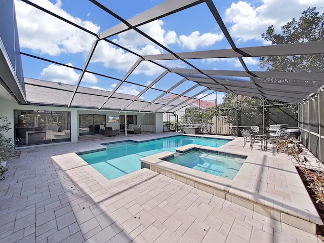 view of pool featuring an outdoor hangout area, a patio area, glass enclosure, and an in ground hot tub