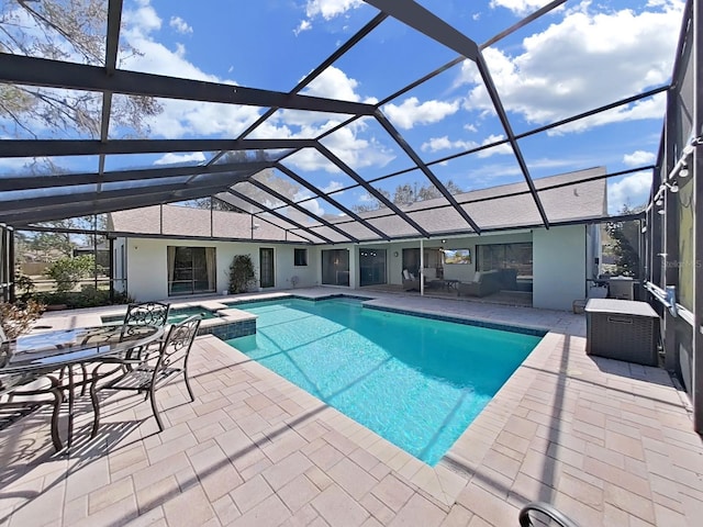 view of pool with a lanai, an outdoor hangout area, and a patio area