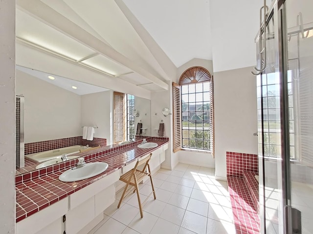 bathroom featuring vaulted ceiling, separate shower and tub, tile patterned floors, and vanity