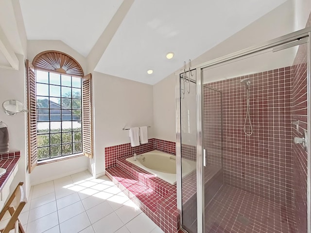 bathroom with a water view, vanity, vaulted ceiling, tile patterned floors, and separate shower and tub