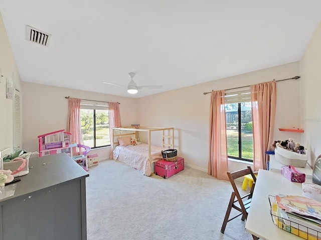 bedroom with ceiling fan and light carpet