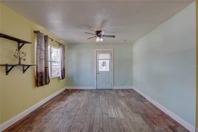 foyer with hardwood / wood-style flooring, ceiling fan, and a textured ceiling