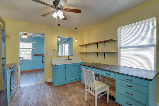 office space featuring sink, ceiling fan, and light wood-type flooring