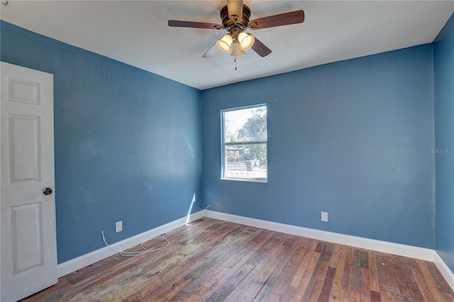 spare room featuring hardwood / wood-style floors and ceiling fan