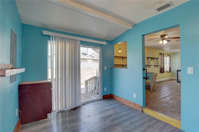 entryway with ceiling fan, hardwood / wood-style floors, and vaulted ceiling with beams