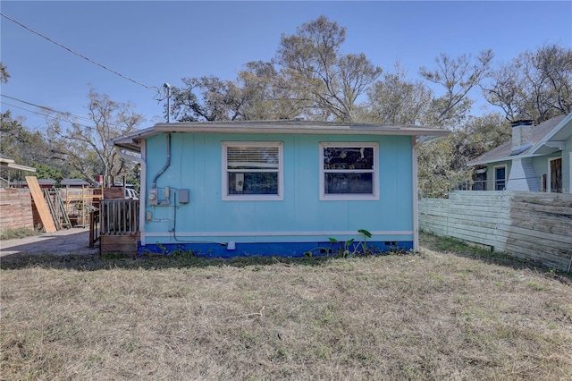 rear view of house with a lawn