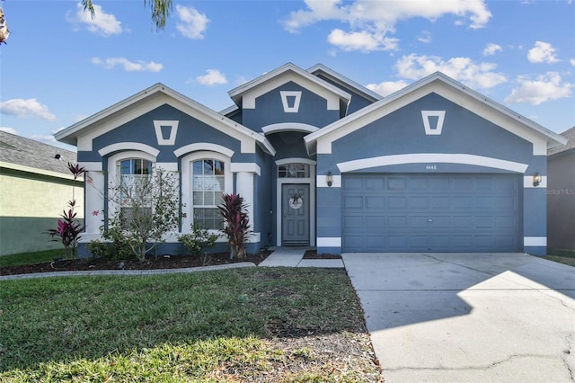 view of front of property featuring a garage and a front lawn