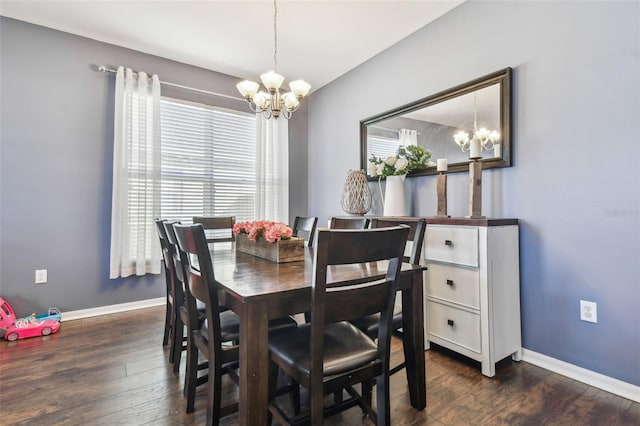 dining space featuring dark hardwood / wood-style floors and a chandelier