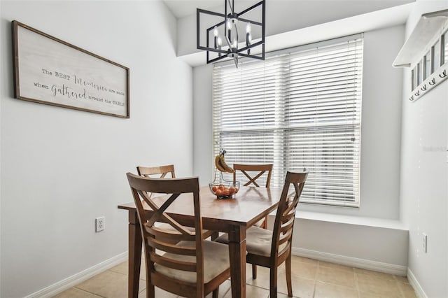 dining space with light tile patterned floors and a notable chandelier