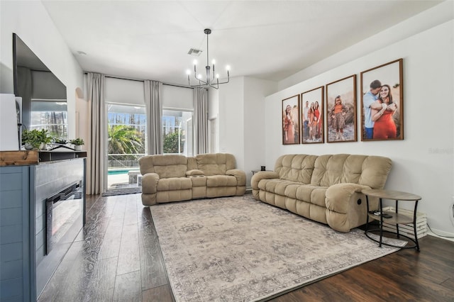 living room with an inviting chandelier and dark hardwood / wood-style flooring