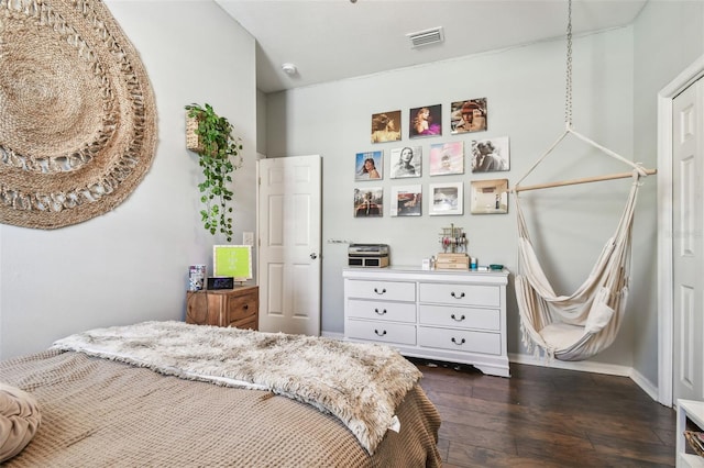 bedroom with dark hardwood / wood-style flooring