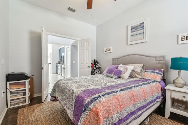 bedroom featuring stainless steel refrigerator, ceiling fan, and hardwood / wood-style floors